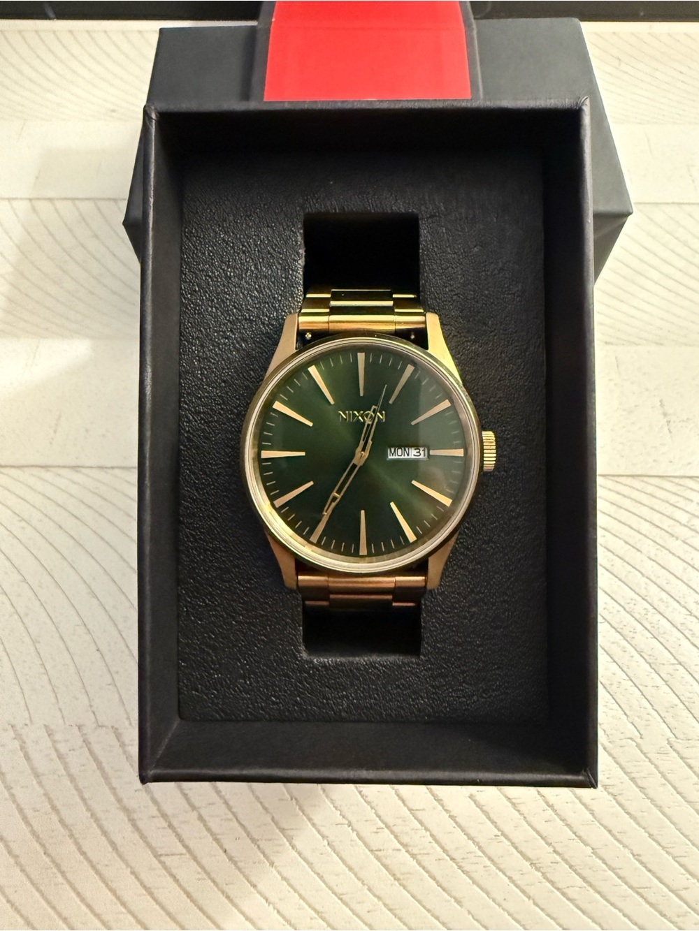 Nixon The Sentry SS men’s watch in gold with green face.
